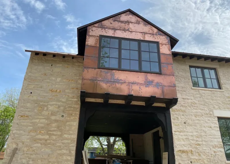 Copper metal panel facade on a stone building for Skylight Installation in Northport